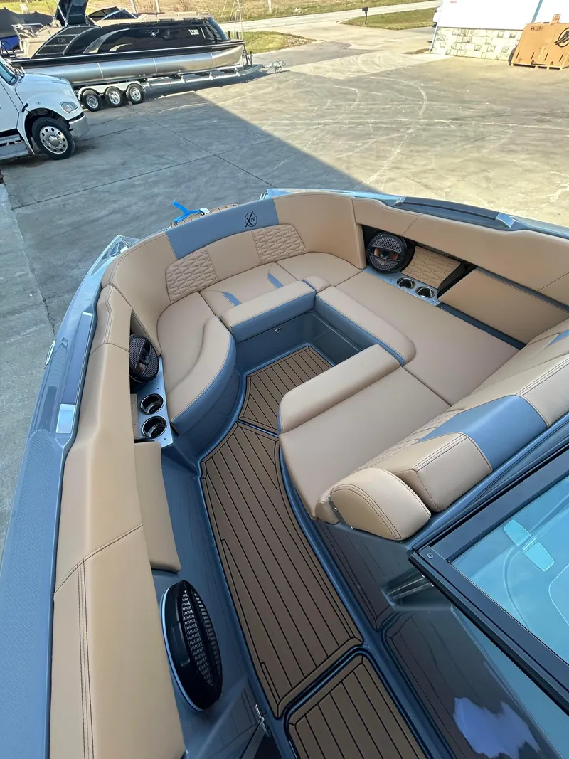 Slide: The Image of 2025 MasterCraft X26 boat interior with tan seating and sleek design. - 15
