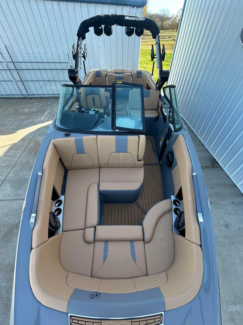 Slide: The Image of 2025 MasterCraft X26 boat with luxurious tan seating and sleek design. - 16