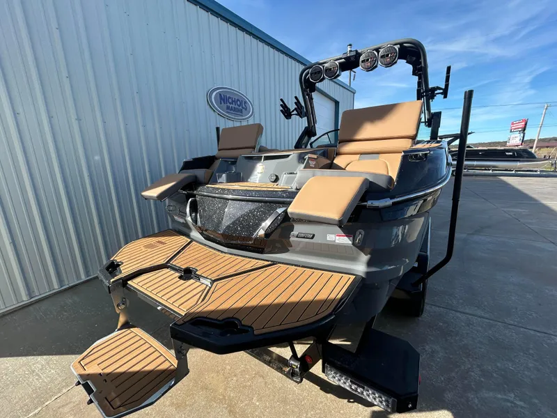Slide: The Image of 2025 MasterCraft X26 boat with teak deck, parked outdoors. - 5