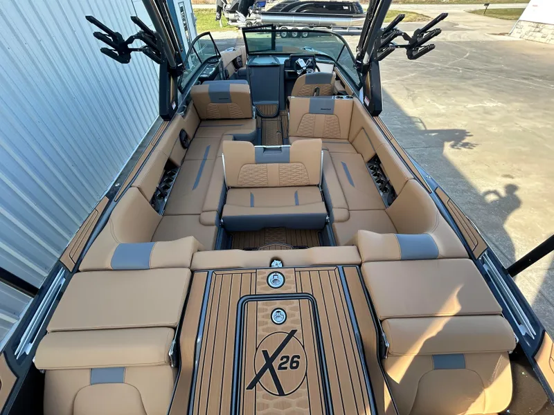 Slide: The Image of 2025 MasterCraft X26 boat interior with luxurious tan seating and sleek design. - 7