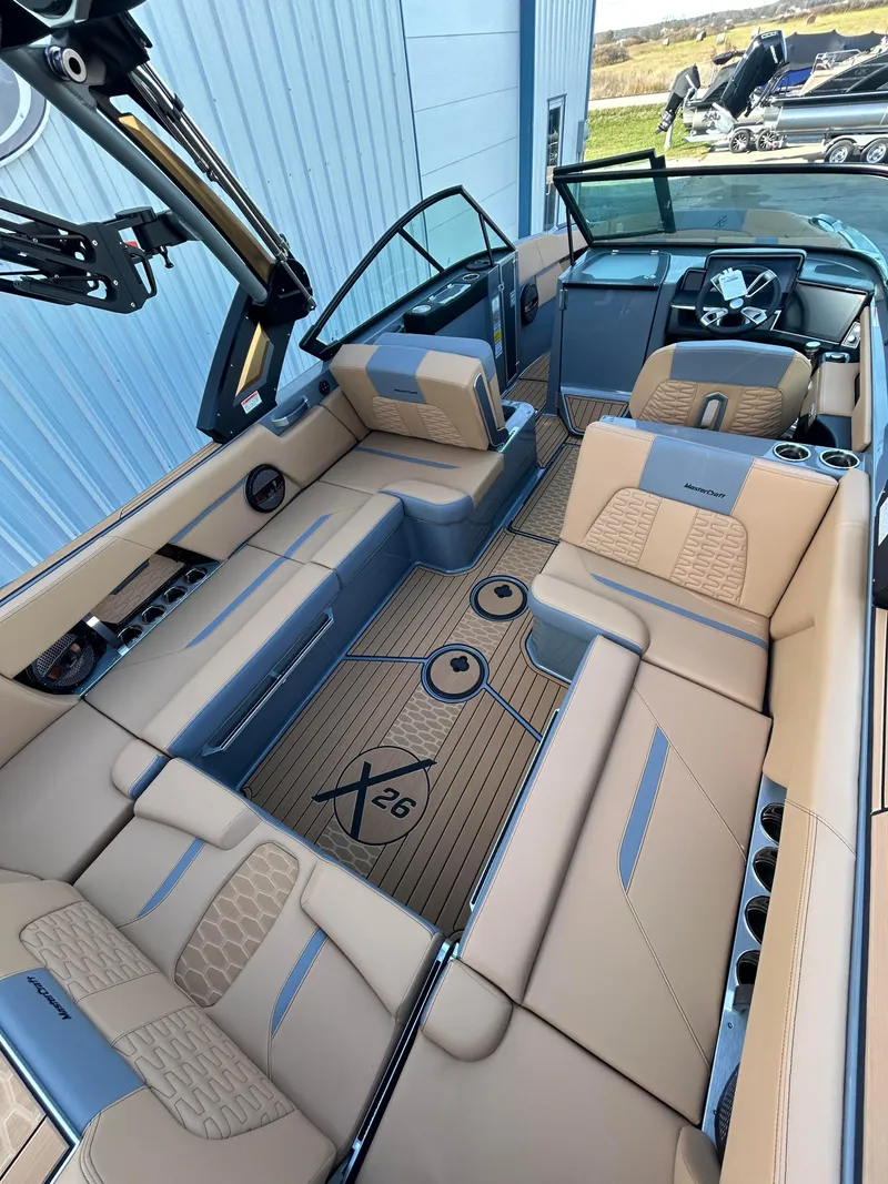 Slide: The Image of 2025 MasterCraft X26 boat interior with luxurious seating and modern design. - 9