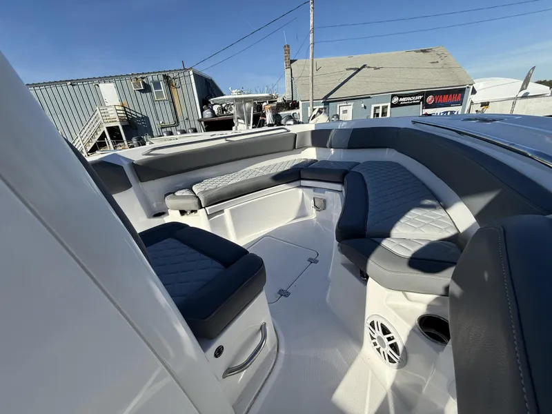 Slide: The Image of 2025 NauticStar 242OS boat interior with cushioned seating and modern design. - 11