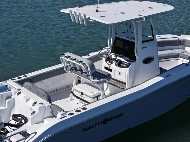 Slide: The Image of 2025 NauticStar 242OS boat on water, featuring modern design and spacious seating. - 5
