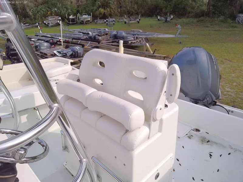 Slide: The Image of 2019 Jones Brothers 26 Cape Fisherman boat with white seating and outboard motor. - 6