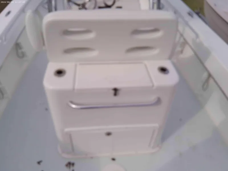 Slide: The Image of Jones Brothers 26 Cape Fisherman 2019 boat interior with white seating and storage. - 7