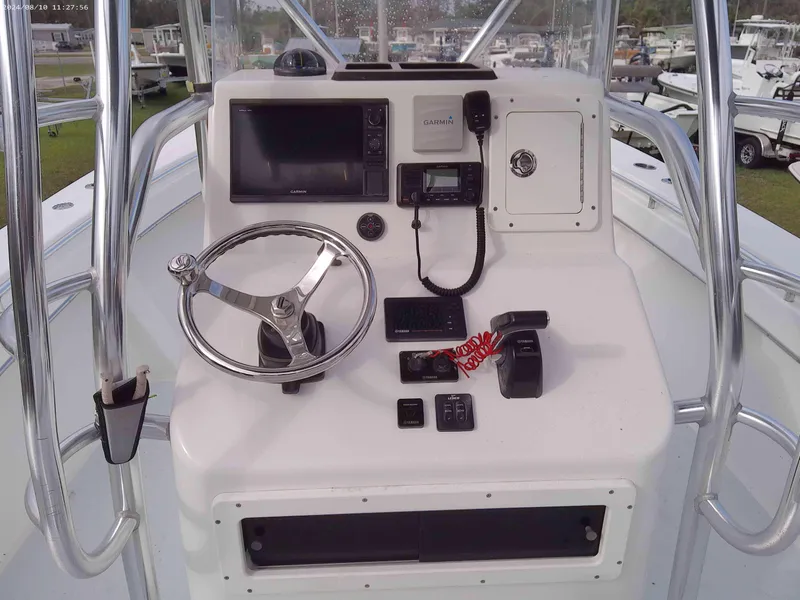 Slide: The Image of 2019 Jones Brothers 26 Cape Fisherman boat console with steering wheel and navigation equipment. - 8