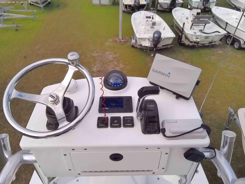 Slide: The Image of 2019 Jones Brothers 26 Cape Fisherman helm with Garmin navigation system and controls. - 9