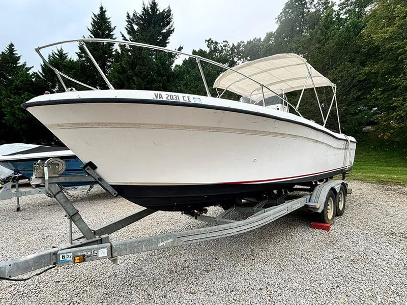The Image of 1985 Grady-White 24 Fisherman boat on trailer, parked on gravel. - 0