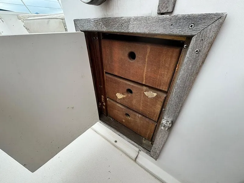 Slide: The Image of Wooden storage compartment on 1985 Grady-White 24 Fisherman boat. - 13