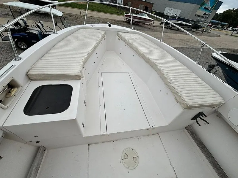 Slide: The Image of 1985 Grady-White 24 Fisherman boat interior with white cushioned seating and storage. - 14