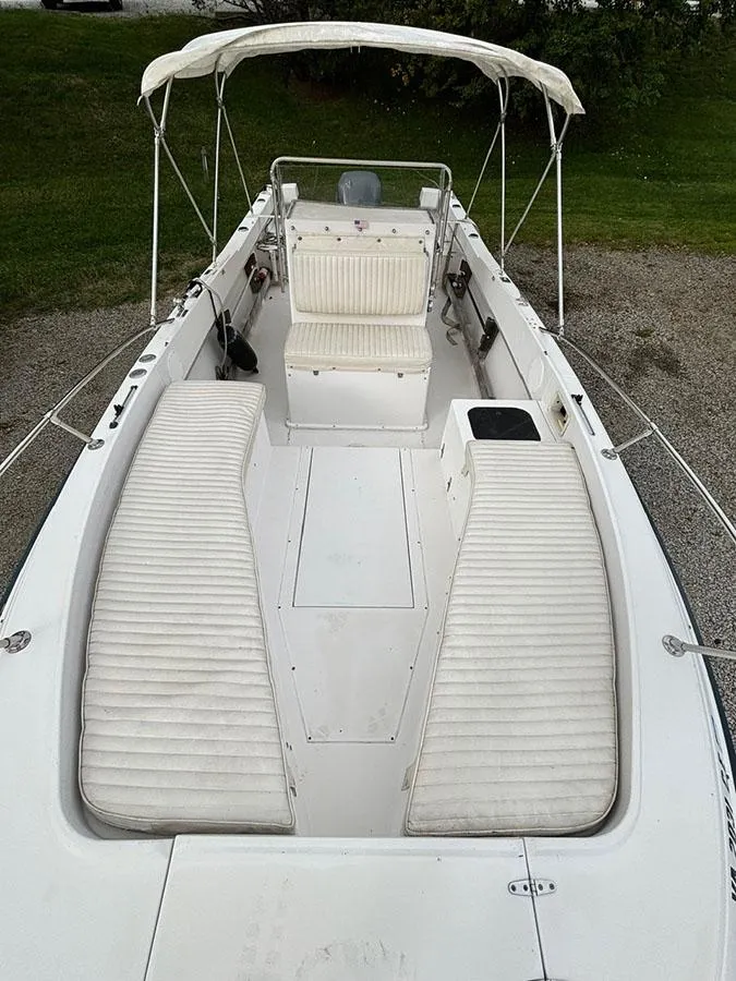 Slide: The Image of 1985 Grady-White 24 Fisherman boat with white seating and canopy. - 16