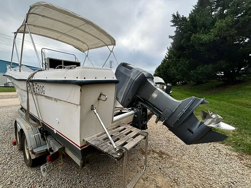 Slide: The Image of 1985 Grady-White 24 Fisherman boat on trailer, outboard motor, canopy, gravel lot. - 5