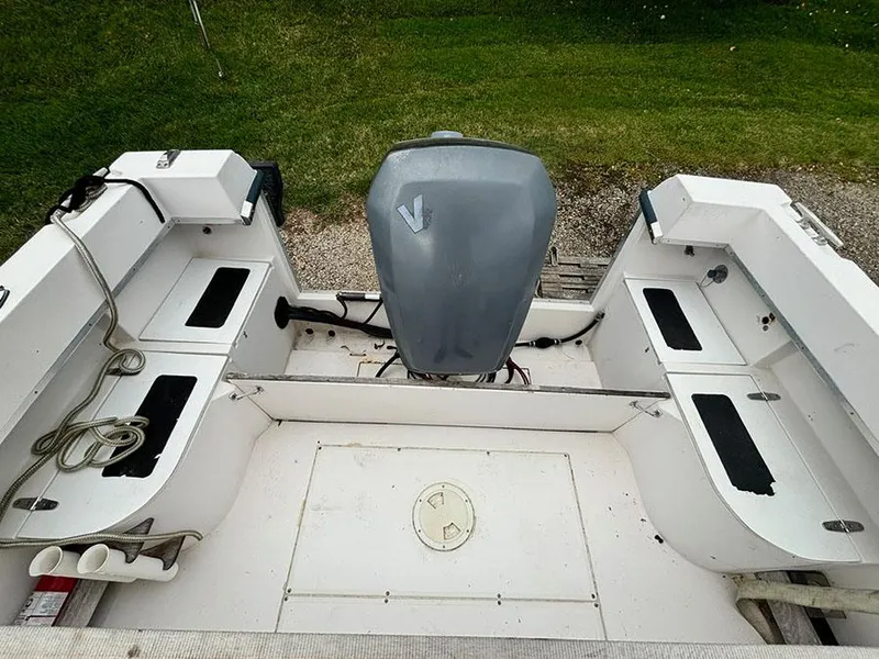 Slide: The Image of 1985 Grady-White 24 Fisherman boat interior with motor, storage compartments, and ropes. - 7