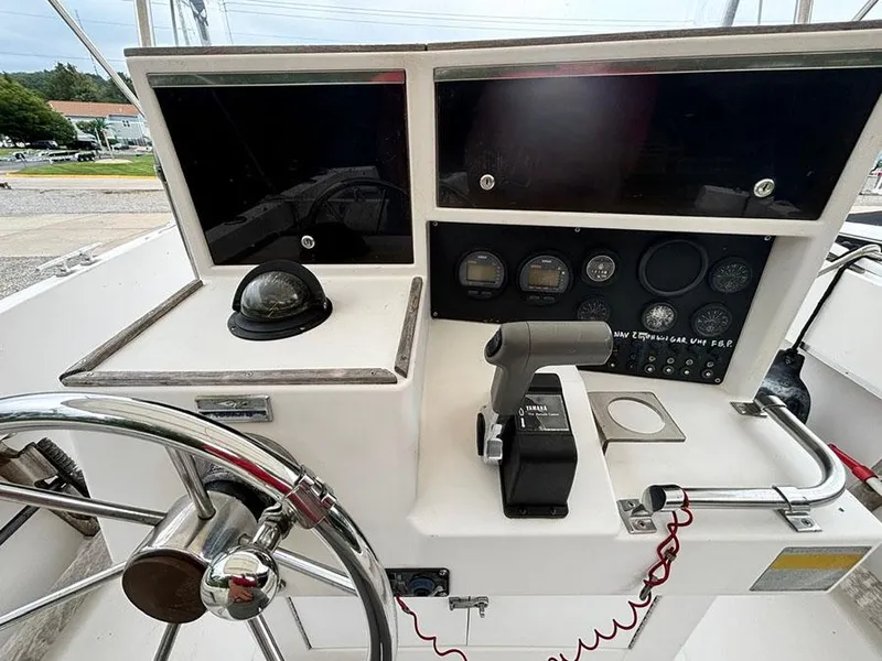 Slide: The Image of Control panel of 1985 Grady-White 24 Fisherman boat with steering wheel and gauges. - 9