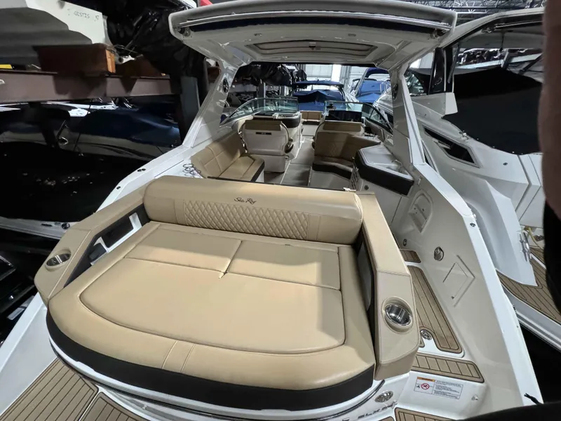 Slide: The Image of 2020 Sea Ray 310SLX boat interior with beige seating and modern design. - 13
