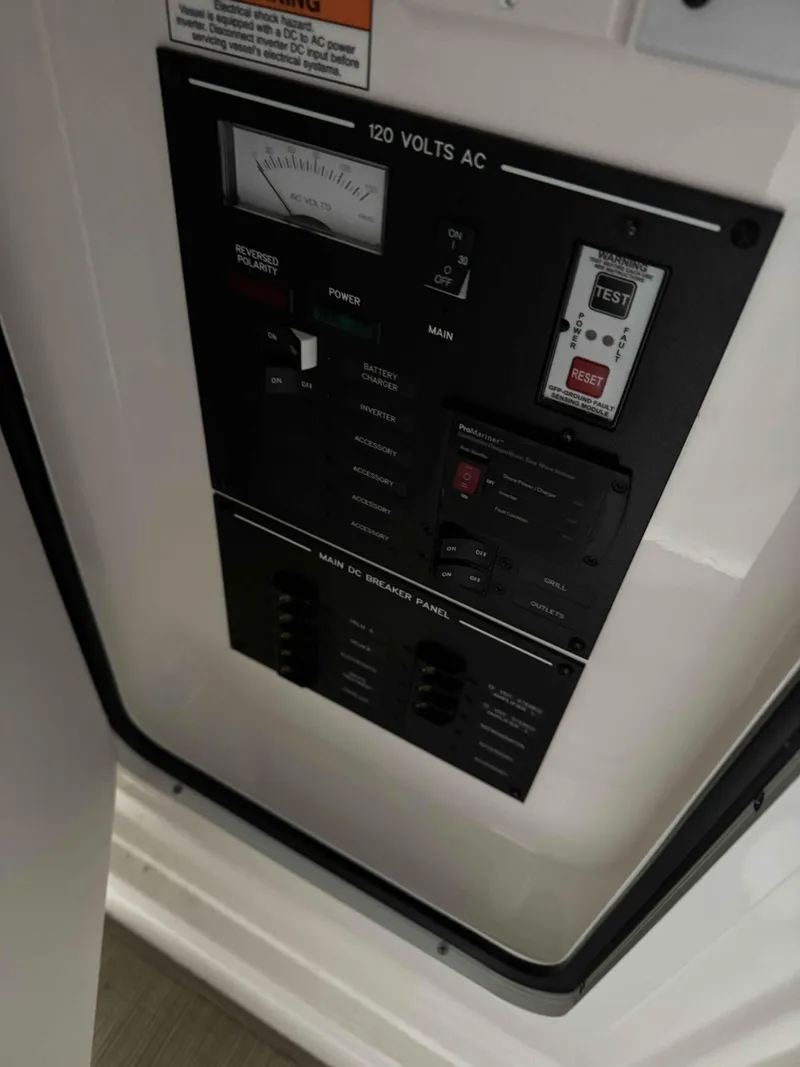 Slide: The Image of Electrical panel of 2020 Sea Ray 310SLX boat, featuring 120 volts AC controls. - 16