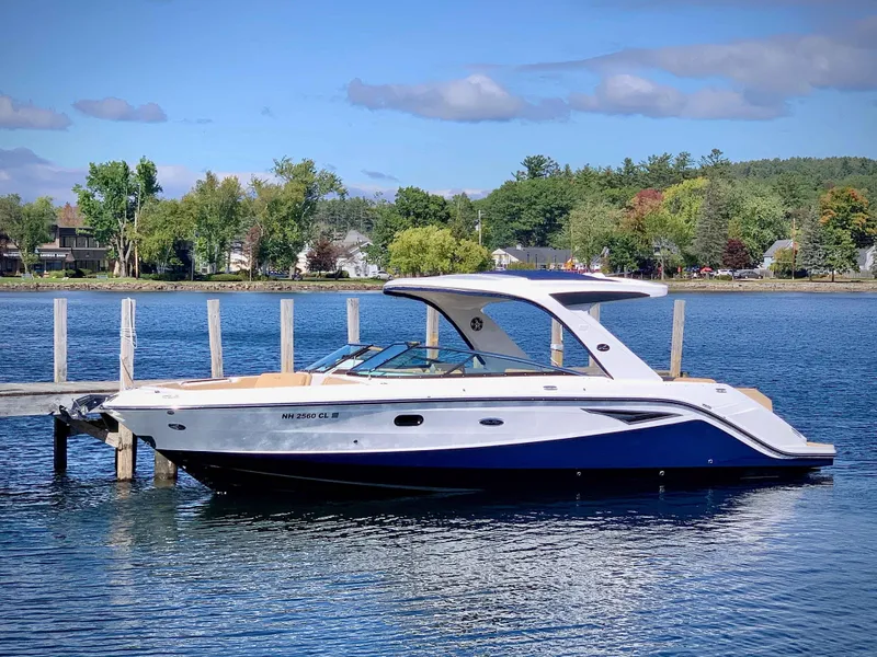 Slide: The Image of 2020 Sea Ray 310SLX boat docked on a serene lake. - 4