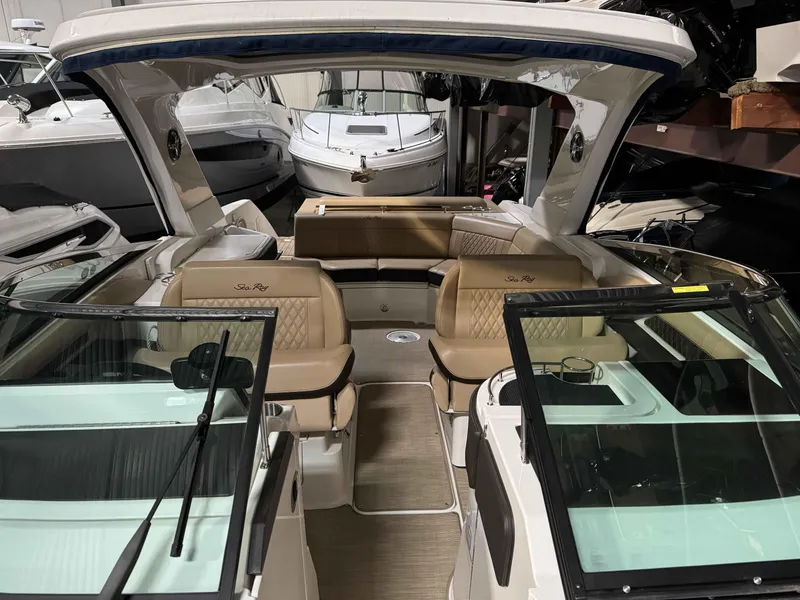 Slide: The Image of 2020 Sea Ray 310SLX boat interior with tan leather seating and glass windshields. - 7