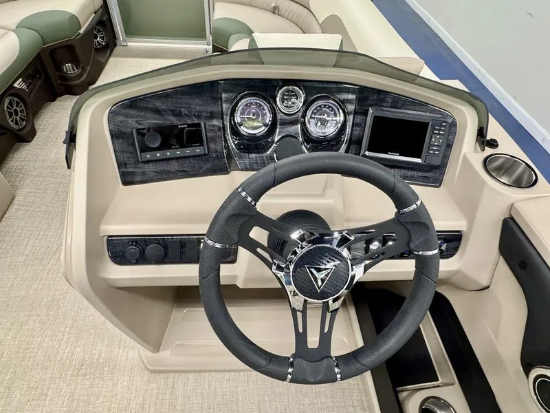 Slide: The Image of 2025 Tahoe LTZ 23 Elite boat dashboard with steering wheel, gauges, and navigation system. - 15