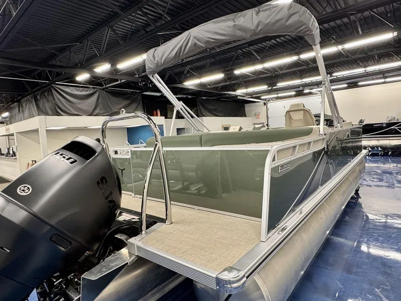 Slide: The Image of 2025 Tahoe LTZ 23 Elite pontoon boat with outboard motor in showroom. - 6