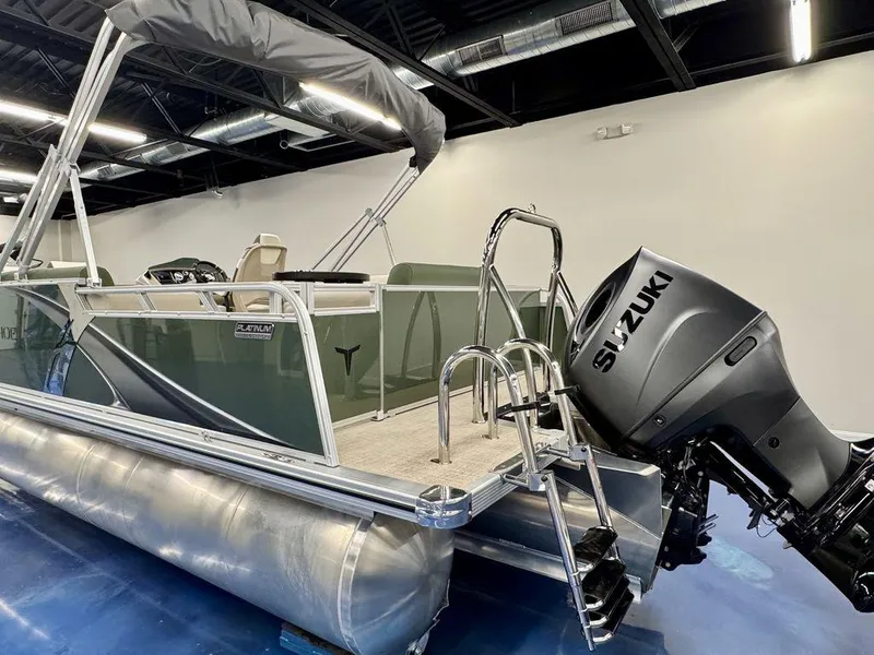 Slide: The Image of 2025 Tahoe LTZ 23 Elite pontoon boat with Suzuki outboard motor in showroom. - 7