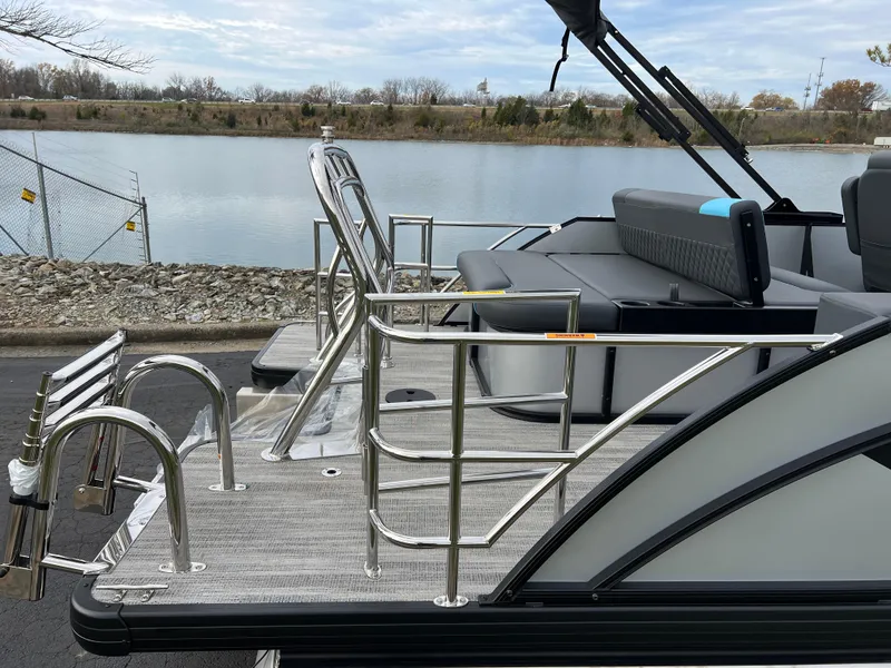 Slide: The Image of 2025 Godfrey Sweetwater 2286 sFLC TRI PWR STR pontoon boat by a lake. - 8