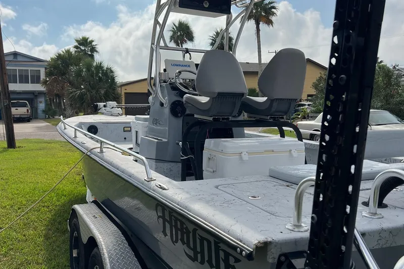 Slide: The Image of 2019 Haynie 25 Magnum boat on trailer, parked in residential area. - 0