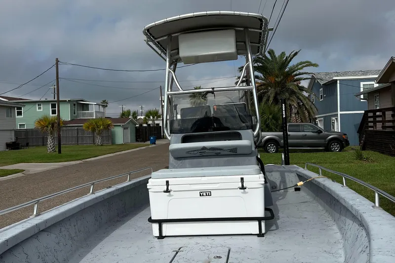 Slide: The Image of 2019 Haynie 25 Magnum boat with Yeti cooler on deck, parked in residential area. - 1