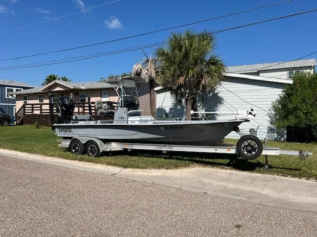Slide: The Image of 2019 Haynie 25 Magnum boat on trailer, parked in residential area. - 10