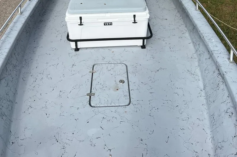 Slide: The Image of 2019 Haynie 25 Magnum boat deck with Yeti cooler and storage hatch. - 5