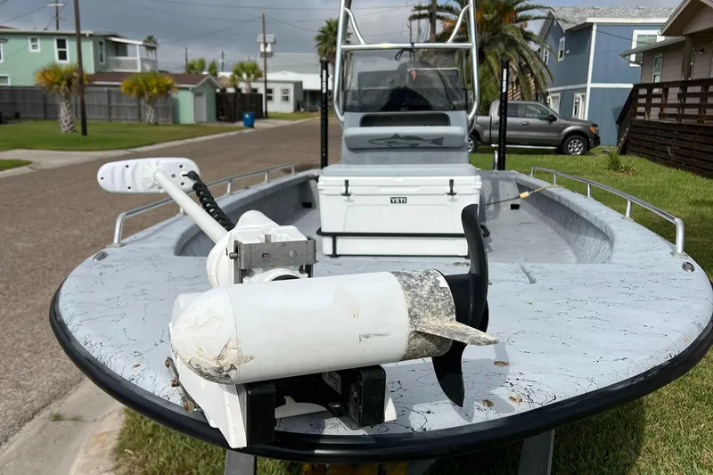 Slide: The Image of 2019 Haynie 25 Magnum boat with trolling motor, parked in a residential area. - 7