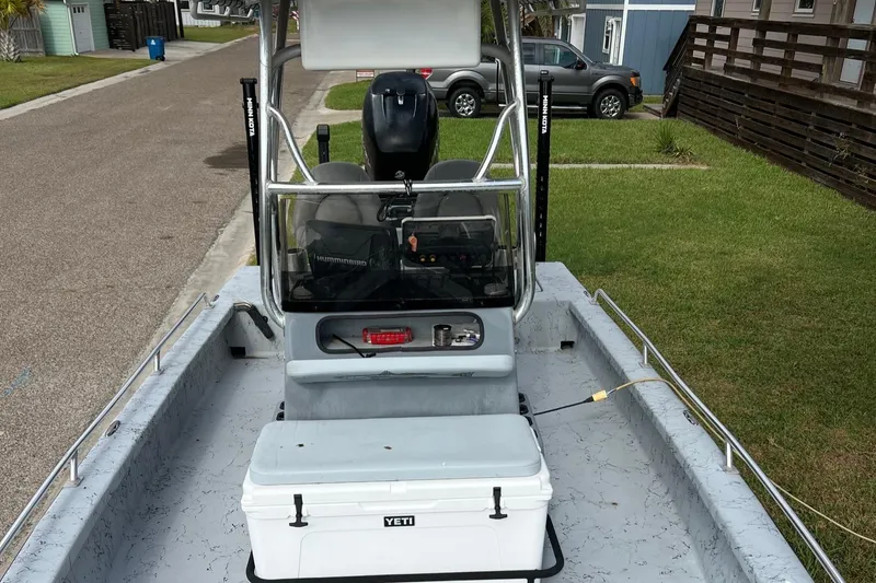 Slide: The Image of 2019 Haynie 25 Magnum boat with Yeti cooler on deck, parked on residential street. - 8