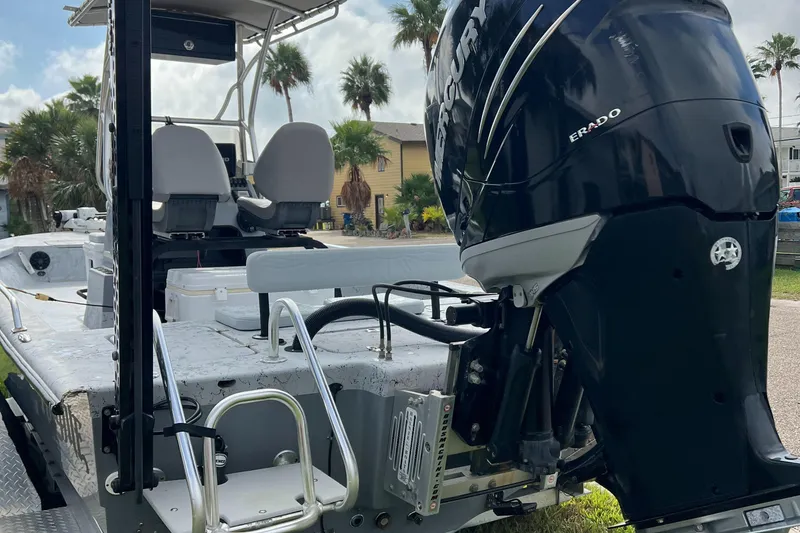 Slide: The Image of 2019 Haynie 25 Magnum boat with powerful outboard motor, parked outdoors. - 9