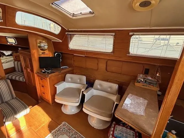 Slide: The Image of Interior of 1980 Irwin 46 Ketch with chairs, table, and nautical decor. - 11