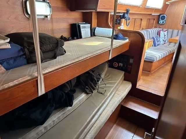 Slide: The Image of Interior of 1980 Irwin 46 Ketch sailboat with cozy wooden bunks and seating area. - 15