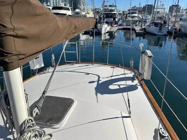 Slide: The Image of 1980 Irwin 46 Ketch sailboat deck view in marina, surrounded by yachts. - 18