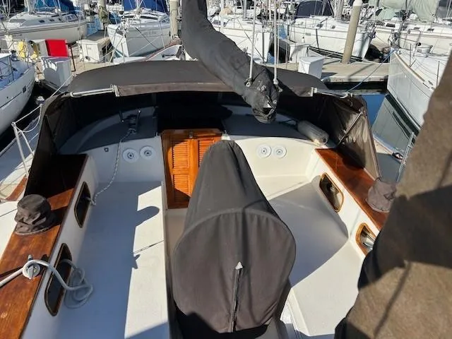 Slide: The Image of 1980 Irwin 46 Ketch sailboat cockpit with covered helm, docked at marina. - 19