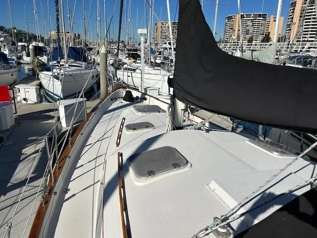 Slide: The Image of 1980 Irwin 46 Ketch sailboat docked in a marina, surrounded by other boats. - 21