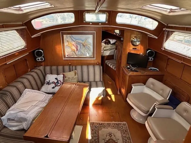 Slide: The Image of Interior of 1980 Irwin 46 Ketch sailboat with cozy seating and nautical decor. - 3