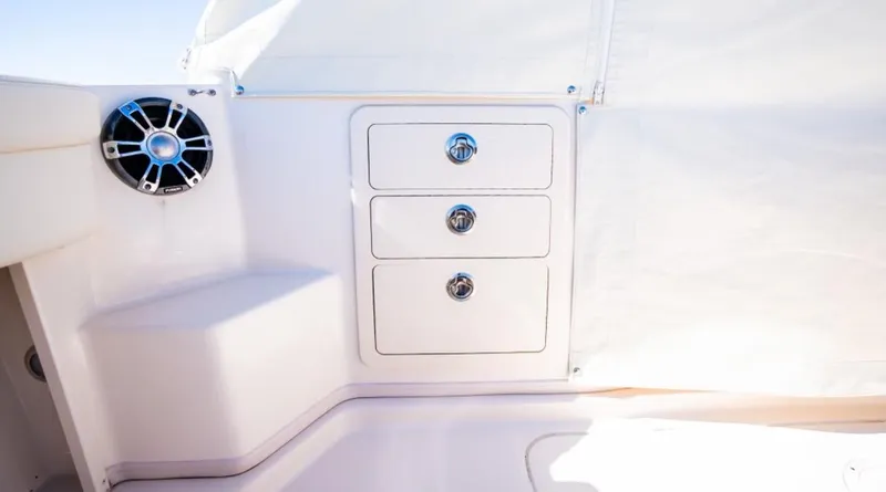 Slide: The Image of 2021 Grady-White Express 330 boat interior with storage drawers and speaker. - 10