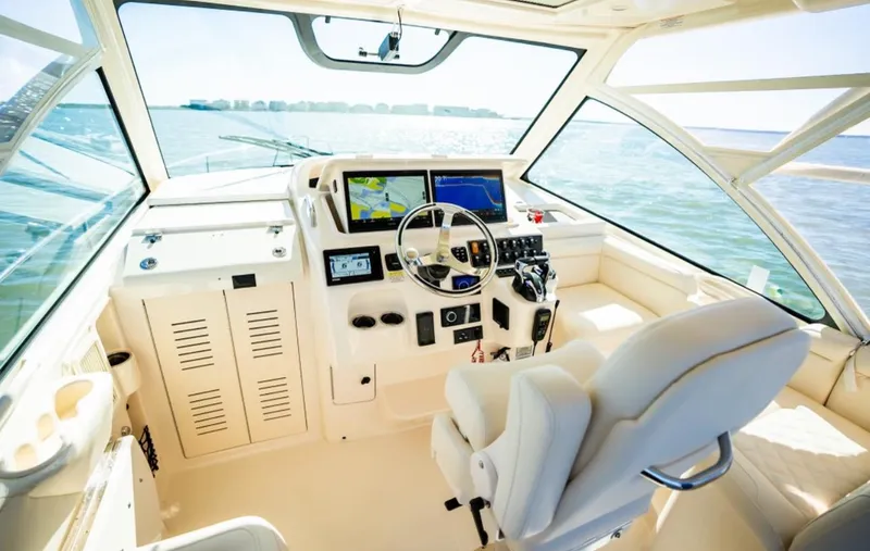 Slide: The Image of 2021 Grady-White Express 330 boat cockpit with modern navigation equipment. - 11