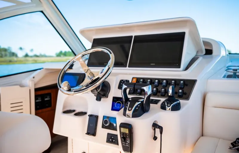 Slide: The Image of 2021 Grady-White Express 330 helm with modern controls and dual displays. - 12