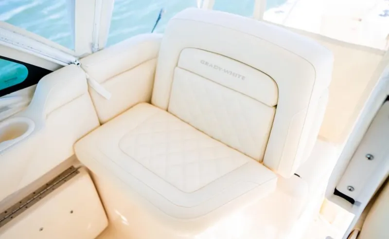 Slide: The Image of Luxurious seating on 2021 Grady-White Express 330 boat, featuring elegant white upholstery. - 15