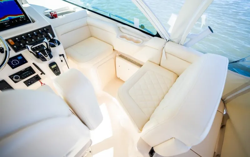 Slide: The Image of 2021 Grady-White Express 330 boat interior with plush seating and modern controls. - 16