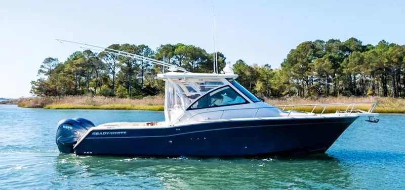 Slide: The Image of 2021 Grady-White Express 330 boat cruising on a serene lake. - 2