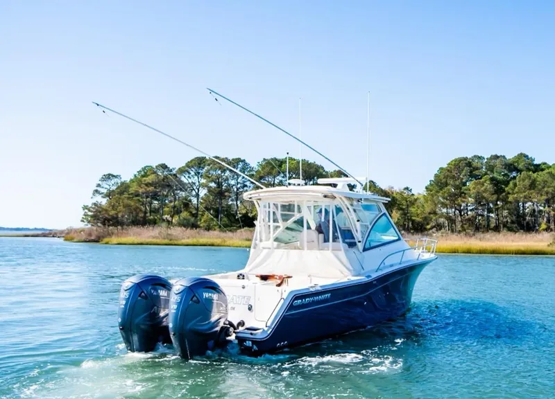 Slide: The Image of 2021 Grady-White Express 330 boat cruising on a serene lake. - 3