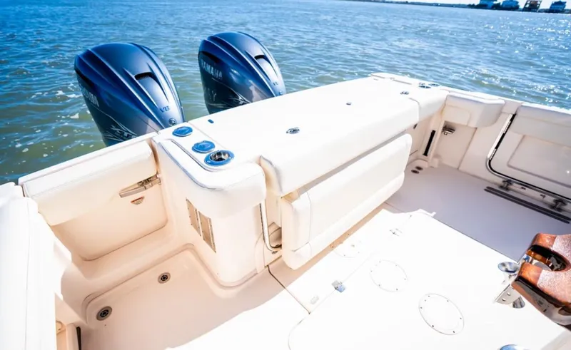 Slide: The Image of 2021 Grady-White Express 330 boat with twin engines on open water. - 7