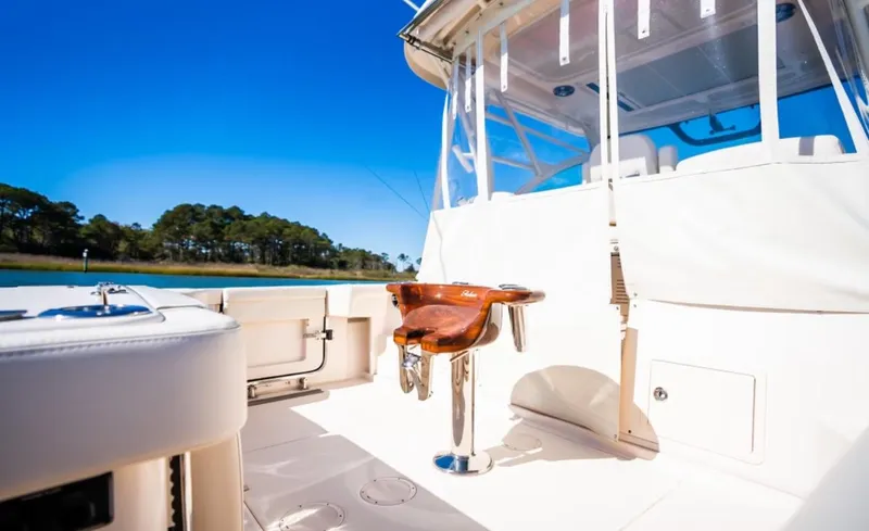 Slide: The Image of 2021 Grady-White Express 330 boat interior with fishing chair, clear blue sky. - 8