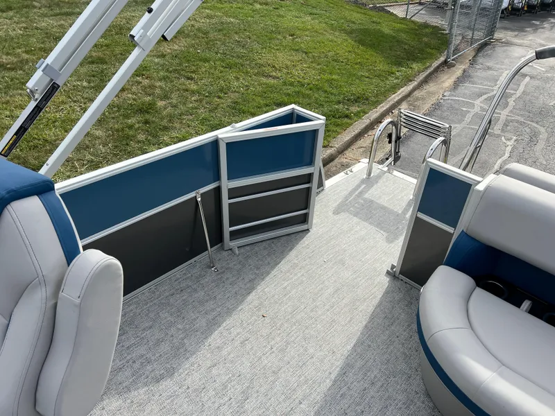 Slide: The Image of 2025 South Bay 222 CR2 LE pontoon boat interior with seating and open gate. - 13