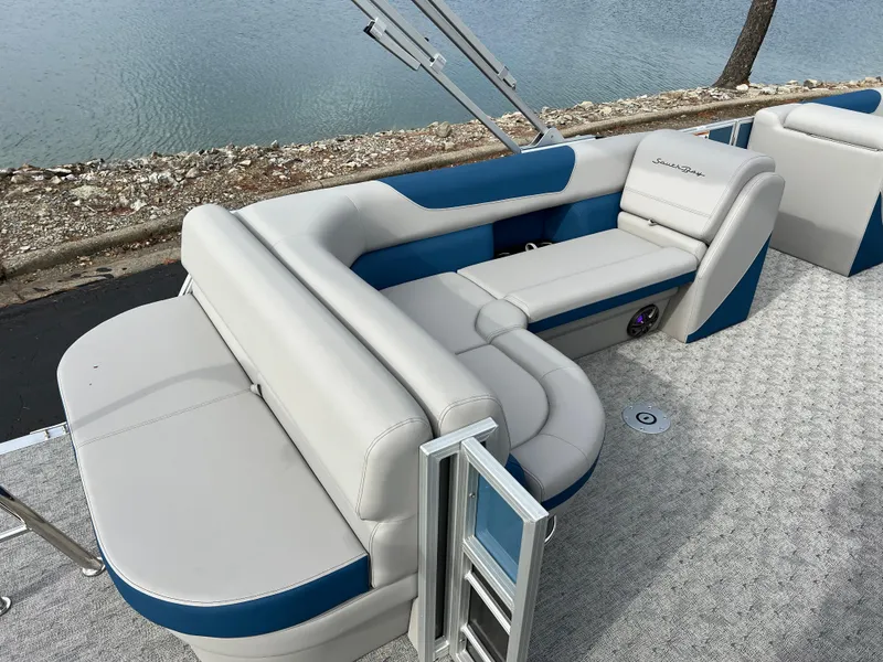 Slide: The Image of 2025 South Bay 222 CR2 LE pontoon boat with stylish seating by the water. - 15